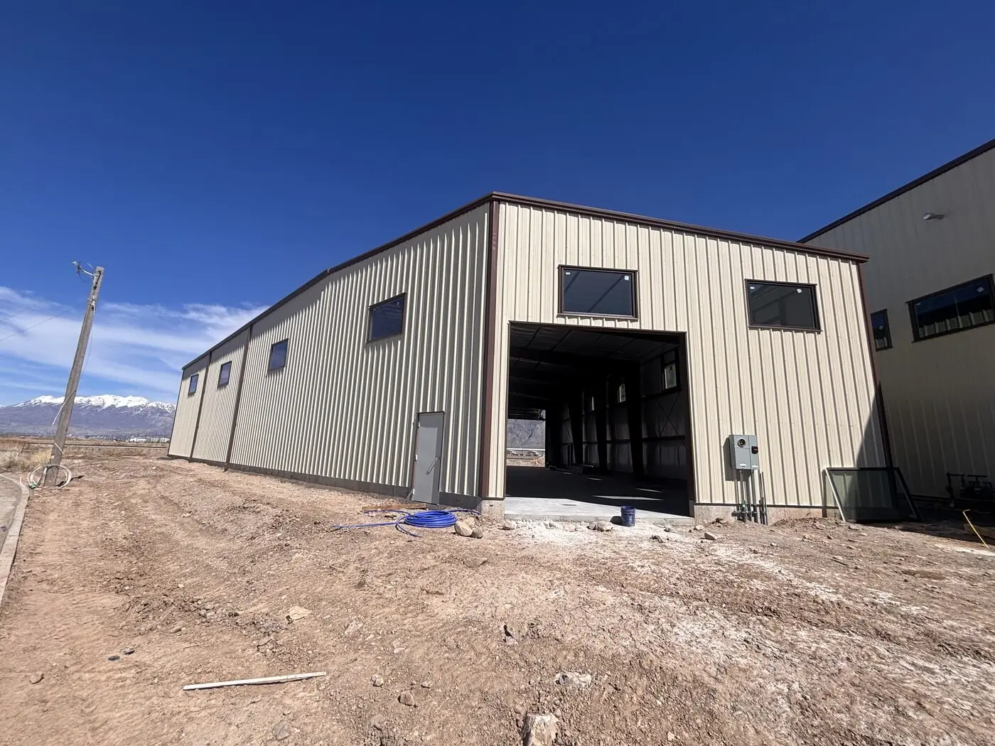 Completed steel building against the Utah mountains